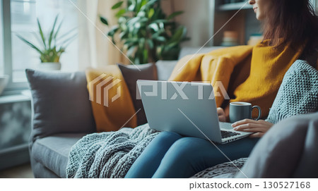 Freelancer working remotely from home with a relaxed and productive setup. Ideal for blogs, tech services, and work-from-home promotions. 130527168