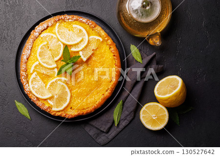 Delicious lemon tart with golden crust and smooth, glossy lemon filling 130527642