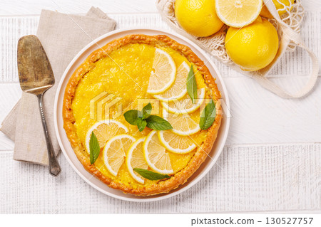 Delicious lemon tart with golden crust and smooth, glossy lemon filling Delicious lemon tart with golden crust and smooth, glossy lemon filling 130527757