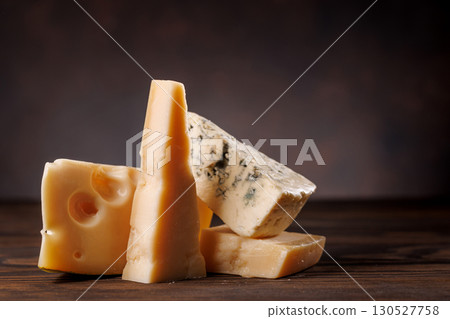 Assorted cheeses in different shapes and textures displayed together 130527758
