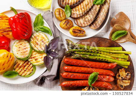 Assorted grilled vegetables including bell peppers, zucchini, eggplant, and sausages Assorted grilled vegetables including bell peppers, zucchini, eggplant, and sausages 130527834