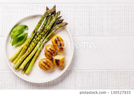 Grilled asparagus and golden baby potatoes 130527835