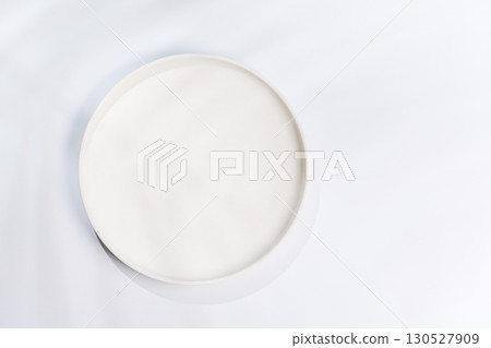 Empty plate on a white background with leaf shadows, perfect food mockup Empty plate on a white background with leaf shadows, perfect food mockup 130527909