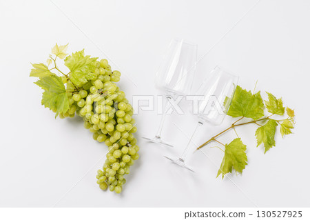 Wine glasses with fresh grapes on a white background, elegant food and drink concept Wine glasses with fresh grapes on a white background, elegant food and drink concept 130527925