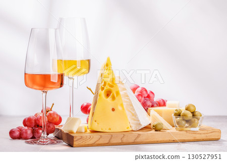 A delectable arrangement of various cheeses, fresh grapes, and wine A delectable arrangement of various cheeses, fresh grapes, and wine 130527951