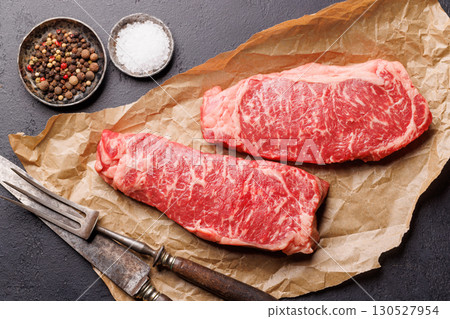 Raw marbled striploin steak, fresh, rich, ready for cooking Raw marbled striploin steak, fresh, rich, ready for cooking 130527954