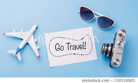 Travel-themed flat lay with card, camera, toy airplane Travel-themed flat lay with card, camera, toy airplane 130528005