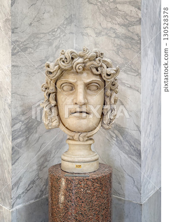 VATICAN CITY, ROME, ITALY - AUGUST 02, 2025 Classical marble head of Medusa, a fearsome Gorgon from Greek mythology with coiling snakes that form her hair, located in the Chiaramonti Museum 130528378