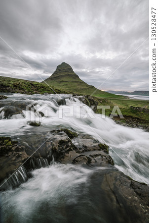 Kirkjufellsfoss Waterfall With Kirkjufell Mountain Near Grundarfjordur City, Iceland 130528477
