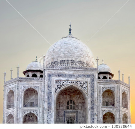 Taj Mahal in Agra, India. Majestic white marble dome and symmetrical structure with ornate inlay, Taj Mahal in Agra, India. Majestic white marble dome and symmetrical structure with ornate inlay, 130528644