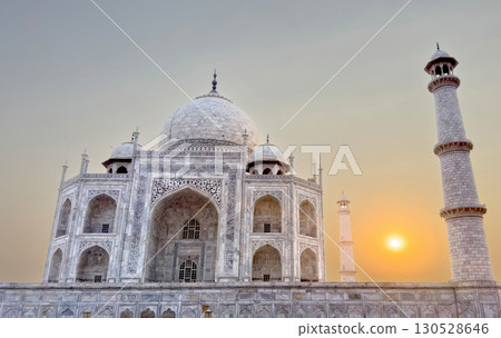 Taj Mahal in Agra, India. Majestic white marble mausoleum with symmetrical facade, ornate carvings, 130528646