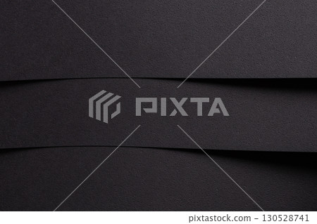 Geometric abstract designer paper texture with dark, monochrome backdrop. Minimalistic, chic surface 130528741