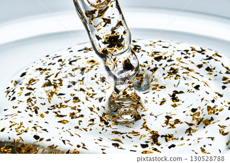 Mouth-watering thick texture of 24k gold serum. Mouth-watering thick texture of 24k gold serum. 130528788