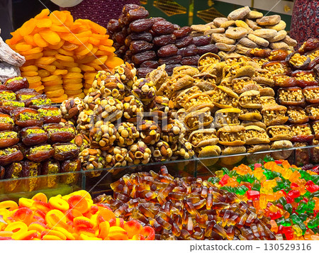 Assortment of sweets, dried fruits, and nuts in a market. Flavor, tradition, and culture in natural and handmade foods. Assortment of sweets, dried fruits, and nuts in a market. Flavor, tradition, and culture in natural and handmade foods. 130529316
