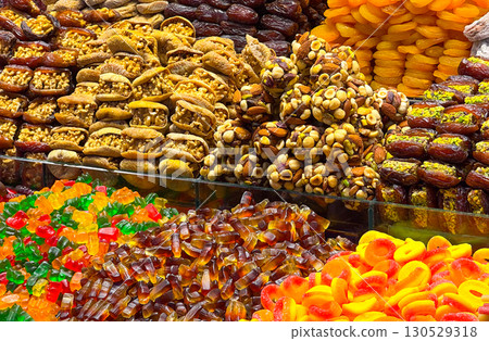Assortment of sweets, dried fruits, and nuts in a market. Flavor, tradition, and culture in natural and handmade foods. 130529318