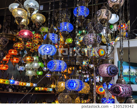 Traditional mosaic lamps glowing in colorful display at bazaar shop. Culture, craft, and heritage representing art, decoration, and tourism lifestyle. 130529342