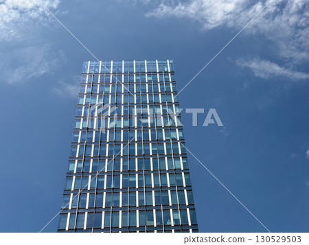 Modern skyscraper with glass facade reflecting bright sky and urban skyline in Belgrade. Business, finance, and contemporary city architecture representing development, infrastructure, and corporate Modern skyscraper with glass facade reflecting bright sky and urban skyline in Belgrade. Business, finance, and contemporary city architecture representing development, infrastructure, and corporate 130529503
