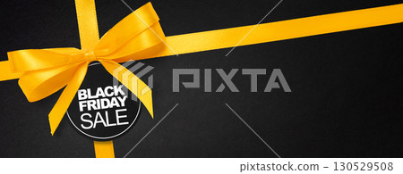 Advertising design for big Black Friday event with luxury ribbon and bold text. Suitable for banners, flyers and digital campaig 130529508