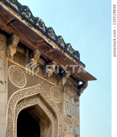 Delhi India October 15 2024 Close up of an intricately carved Islamic stone arch and overhanging 130529698