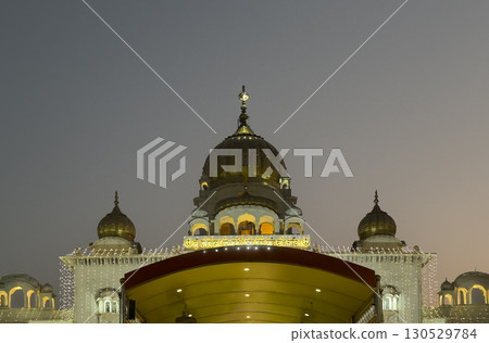 Gurudwara Bangla Sahib, Delhi. Sacred Sikh temple with a golden dome, illuminated at dusk. Ornate, Gurudwara Bangla Sahib, Delhi. Sacred Sikh temple with a golden dome, illuminated at dusk. Ornate, 130529784