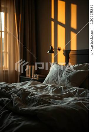 Soft sheets and cozy atmosphere in bedroom interior. 130529882