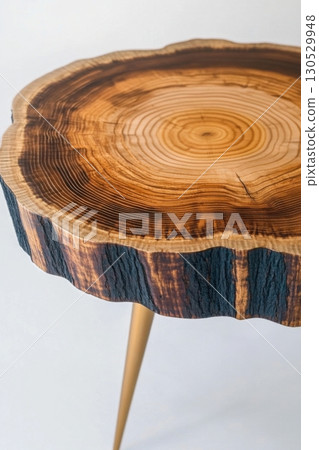 Wooden coffee table with natural tree rings and rustic bark edge 130529948