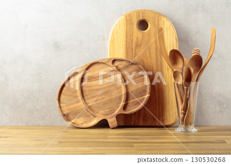Wooden kitchen utensils on a wooden table. 130530268