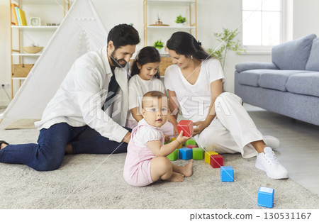Young family playing with children at home together 130531167