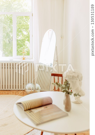 Interior of light living room with sofas, rattan table and soft carpet 130531189
