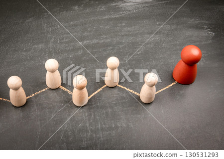 Social exclusion or disconnection concept with wooden figures and chalk line on dark background 130531293