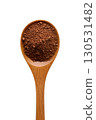 Wooden spoon filled with rich brown cocoa powder, baking ingredient for desserts or hot chocolate, isolated 130531482