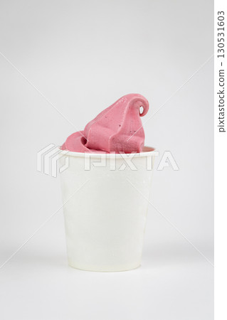 Vibrant pink berry soft serve in white cup, close-up shot on light background Vibrant pink berry soft serve in white cup, close-up shot on light background 130531603