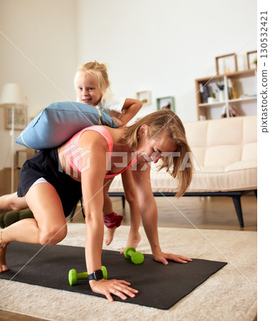 Mother Exercising at Home While Bonding with Her Daughter 130532421