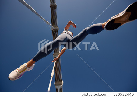 Low-angle view of a person running across a bridge in activewear 130532440