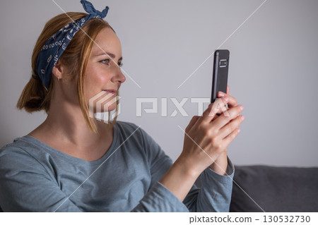 Middle aged millennial woman holding smartphone, social media, communication and modern technology Middle aged millennial woman holding smartphone, social media, communication and modern technology 130532730