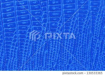 Bold luminous blue faux reptile texture with deep scales and glossy surface. Concept of exotic elegance, futuristic fashion, standout texture 130533365