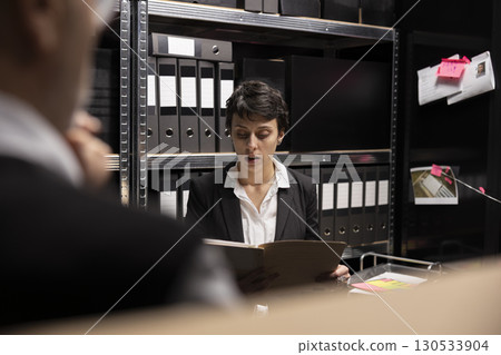 Detectives team conducting a private investigation with forensic evidence, working together to connect the dots and catch a criminal. Organizing confidential records in incident room. Detectives team conducting a private investigation with forensic evidence, working together to connect the dots and catch a criminal. Organizing confidential records in incident room. 130533904