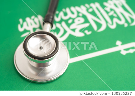 Stethoscope on Saudi Arabia flag background, Business and finance. Stethoscope on Saudi Arabia flag background, Business and finance. 130535227