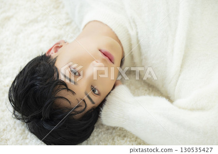 Lying man in knitwear Lying man in knitwear 130535427