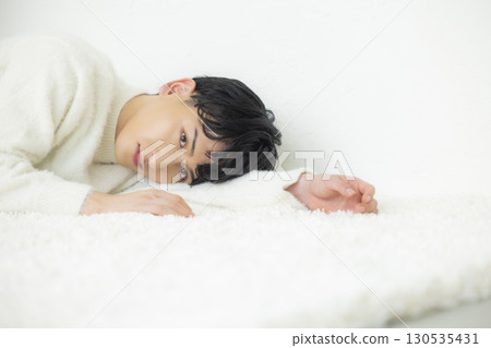 Lying man in knitwear 130535431