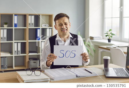 Portrait of a Troubled Businessman with Sos Sign 130535791