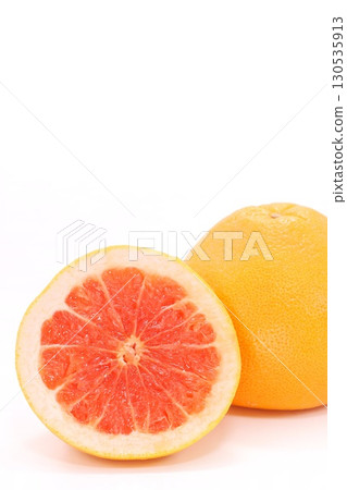 Grapefruit cut cross section red flesh light background 130535913