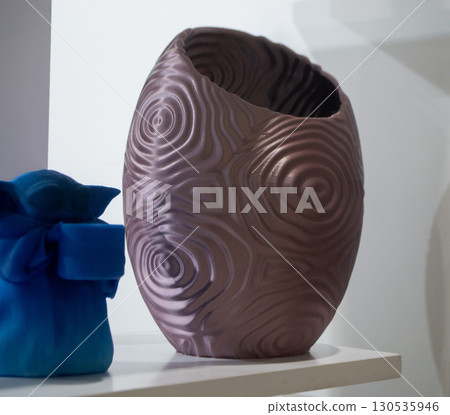 Object printed on 3D printer close up. Model printed on 3D printer from molten plastic. Vase printed on 3D printer from molten plastic of brown color. 3D printing technology. Additive FDM technologies 130535946