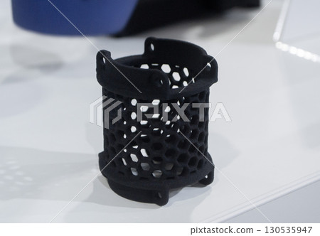 Object printed on 3D printer from molten plastic powder close-up. Model printed on 3D printer from melted polyamide powder. New modern additive 3D printing technology. Multi Jet Fusion MJF technology Object printed on 3D printer from molten plastic powder close-up. Model printed on 3D printer from melted polyamide powder. New modern additive 3D printing technology. Multi Jet Fusion MJF technology 130535947