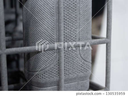 Object printed on 3D printer from molten plastic powder close-up. Model printed on 3D printer from melted polyamide powder. New modern additive 3D printing technology. Multi Jet Fusion MJF technology 130535959