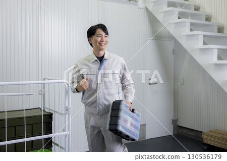 一名身穿工作服的男子推著推車 130536179