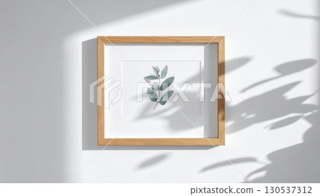 Botanical Artwork in Wood Frame with White Border on a White Wall with Natural Light and Shadows 130537312