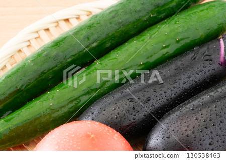 Close-up of fresh cucumber, eggplant and tomato (summer vegetables) Close-up of fresh cucumber, eggplant and tomato (summer vegetables) 130538463