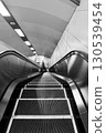 Subway entrance: Long escalator leading down "Sapporo Subway Shin-Sapporo Station" black and white 130539454