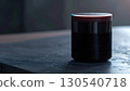 Sleek Black Cylinder Speaker with Star Pattern on Gray Tabletop Minimalist Design 130540718